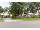 Exterior ground view of the house showing driveway and front gate at 11109 Sumner Rd, Wimauma, FL 33598