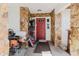 Entrance and enclosed front porch of house with stone detailing at 11109 Sumner Rd, Wimauma, FL 33598