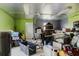 View of a cluttered garage filled with assorted storage containers, furniture, and random household items at 11109 Sumner Rd, Wimauma, FL 33598