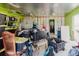View of a cluttered garage featuring packed storage bins, various items, and an open doorway at 11109 Sumner Rd, Wimauma, FL 33598