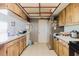 Kitchen with tile floors, wood cabinets, white countertops, and stainless steel refrigerator at 11109 Sumner Rd, Wimauma, FL 33598