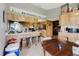 Farmhouse style kitchen with wood cabinets, white countertops, and breakfast bar seating three at 11109 Sumner Rd, Wimauma, FL 33598