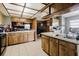 Traditional kitchen featuring wood cabinetry, tiled floors, and an efficient layout at 11109 Sumner Rd, Wimauma, FL 33598