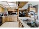 Classic kitchen showcasing wood cabinets, stainless sink, and an open layout at 11109 Sumner Rd, Wimauma, FL 33598