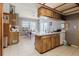 Bright kitchen featuring white countertops, wood cabinets, and a view to the dining area at 11109 Sumner Rd, Wimauma, FL 33598