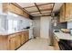 Kitchen with white countertops, wood cabinets, stainless steel refrigerator, and dishwasher at 11109 Sumner Rd, Wimauma, FL 33598