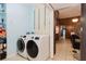 Laundry room featuring washer, dryer, and blue paint at 11109 Sumner Rd, Wimauma, FL 33598