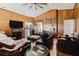Spacious living room with wood paneling, tile flooring, and open access to kitchen at 11109 Sumner Rd, Wimauma, FL 33598