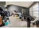 Sunlit living room featuring modern flooring, and a dog kennel at 11109 Sumner Rd, Wimauma, FL 33598