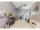 Living room with neutral walls, tile flooring, a ceiling fan, and various storage solutions at 11109 Sumner Rd, Wimauma, FL 33598