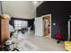 Spacious living room with sleek flooring, a dog kennel and ample natural light at 11109 Sumner Rd, Wimauma, FL 33598
