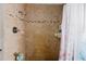 A shower area featuring stylishly tiled walls and a shower curtain at 11109 Sumner Rd, Wimauma, FL 33598