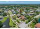 Aerial view showcasing the neighborhood's layout, pond, and proximity to lush greenery at 1111 Chatham Ct, Safety Harbor, FL 34695