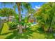 Lush backyard featuring a private pool, tropical landscaping and a screen enclosure at 1111 Chatham Ct, Safety Harbor, FL 34695