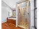 Bright bathroom featuring a walk-in shower with mosaic tile floor and a soaking tub by a window at 1111 Chatham Ct, Safety Harbor, FL 34695