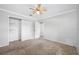 Bright bedroom features a ceiling fan, neutral walls, and carpet flooring at 1111 Chatham Ct, Safety Harbor, FL 34695