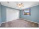 Cozy bedroom featuring a ceiling fan, closet, and window at 1111 Chatham Ct, Safety Harbor, FL 34695