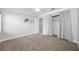 Neutral-toned bedroom has carpet flooring, ceiling fan, and a closet with curtains at 1111 Chatham Ct, Safety Harbor, FL 34695