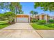 Charming one-story home with a two-car garage, manicured lawn and beautiful landscaping at 1111 Chatham Ct, Safety Harbor, FL 34695