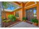 Front door showcasing the tiled entryway, complemented by fresh landscaping and a welcoming mat at 1111 Chatham Ct, Safety Harbor, FL 34695