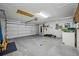 Spacious garage with an automatic door, storage, and concrete floors at 1111 Chatham Ct, Safety Harbor, FL 34695