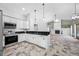 Kitchen boasting stainless steel appliances, white cabinetry, and bar stool seating overlooking the living area at 1111 Chatham Ct, Safety Harbor, FL 34695