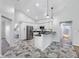 Open kitchen featuring white cabinets, stainless appliances, black countertops, and decorative tile floors at 1111 Chatham Ct, Safety Harbor, FL 34695
