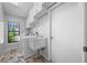 Well-lit laundry room featuring a washer, dryer, sink and tiled floors at 1111 Chatham Ct, Safety Harbor, FL 34695