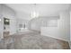 Large, light-filled living area features vaulted ceilings and sliding glass doors to a private outdoor space at 1111 Chatham Ct, Safety Harbor, FL 34695