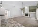 Bright living room with fireplace, ceiling fan, and tile/carpet flooring at 1111 Chatham Ct, Safety Harbor, FL 34695