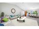 Spacious living room features vaulted ceilings, plush seating, and seamless access to the dining area at 1111 Chatham Ct, Safety Harbor, FL 34695