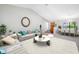 Bright living room featuring stylish modern furnishings, vaulted ceiling and an adjacent dining area with ample natural light at 1111 Chatham Ct, Safety Harbor, FL 34695