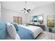 Bright primary bedroom featuring a vaulted ceiling, ceiling fan, and private outdoor access at 1111 Chatham Ct, Safety Harbor, FL 34695