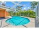 Sparkling pool surrounded by lush landscaping and a screened enclosure at 1111 Chatham Ct, Safety Harbor, FL 34695
