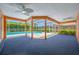 Covered outdoor patio with ceiling fans overlooking the sparkling blue pool at 1111 Chatham Ct, Safety Harbor, FL 34695