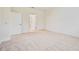 A bright, empty bedroom with neutral carpeting and modern white paneled doors at 11303 Striped Bass Ct, New Port Richey, FL 34654