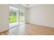 Bright bedroom with wood-look flooring and sliding glass doors to the outdoor patio at 11303 Striped Bass Ct, New Port Richey, FL 34654