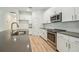 A spacious kitchen featuring white cabinets, gray countertops and stainless steel appliances at 11303 Striped Bass Ct, New Port Richey, FL 34654
