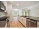 Kitchen view of open floor plan with stainless steel appliances and sliding door to backyard at 11303 Striped Bass Ct, New Port Richey, FL 34654