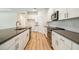 A view of the kitchen featuring white cabinets, stainless steel appliances and modern finishes at 11303 Striped Bass Ct, New Port Richey, FL 34654