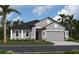 Lovely single-story home with a gray exterior, accented by white trim and a welcoming red front door at 11324 Striped Bass Ct, New Port Richey, FL 34654