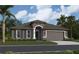 Charming single-story home with a neutral gray exterior, arched entry, and well-manicured landscaping at 11324 Striped Bass Ct, New Port Richey, FL 34654