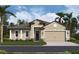 Beautiful single-story home featuring a light beige exterior, columned entry, and well-maintained front lawn at 11324 Striped Bass Ct, New Port Richey, FL 34654