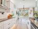 Modern kitchen featuring white cabinets, stainless steel appliances, and a breakfast nook with scenic outdoor views at 11324 Striped Bass Ct, New Port Richey, FL 34654