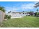 Fenced backyard with a patio area, lush lawn, and mature landscaping at 11416 126Th N Ave, Largo, FL 33778