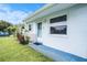 Close-up of a single-story home's entrance with a manicured lawn and vibrant flowerbed at 11416 126Th N Ave, Largo, FL 33778