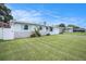 Inviting single-story home with a bright exterior, blue shutters, and a lush green lawn at 11416 126Th N Ave, Largo, FL 33778