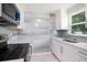 Bright kitchen featuring modern appliances and gray backsplash at 11416 126Th N Ave, Largo, FL 33778