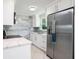 Modern kitchen showcasing stainless steel appliances, quartz countertops, and stylish backsplash at 11416 126Th N Ave, Largo, FL 33778
