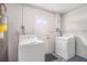 Functional laundry room with washer, dryer, water heater, and access to the exterior at 11416 126Th N Ave, Largo, FL 33778